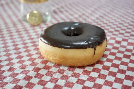 Puebla, Puebla / Mexico - December 24 2019: Editorial illustrative view of chocolate donut over a white and red tableclothのeditorial素材