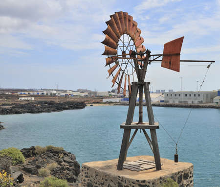old wind generator on the sea shoreの写真素材