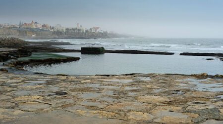 view of the stone coastline at Cascais, Portugalの写真素材