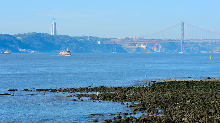 coast of river Tagus and the 25th of April Bridge, Lisbon, Portugalの写真素材