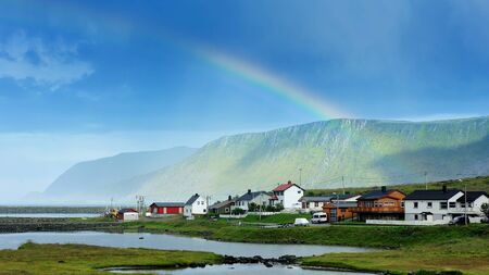rainbow over Skarsvag village in the coast of Risfjorden,Norwayの写真素材