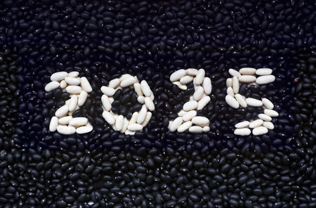 Happy new year 2025 written with white and black beansのeditorial素材