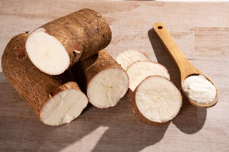 Raw cassava starch - Manihot esculenta. Wood background