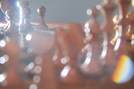 Defocused chess pieces with light reflectionsの写真素材