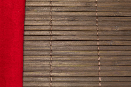 A red cloth napkin on a brown placemat