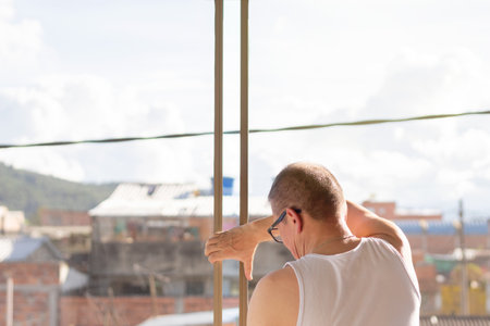 Unrecognizable man installing a window in his house on a sunny dayの写真素材