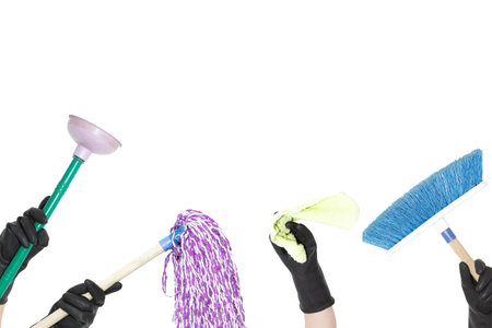 People in black rubber gloves holding cleaning products on a white background. Plunger, mop, cleaning cloth and broom.の写真素材