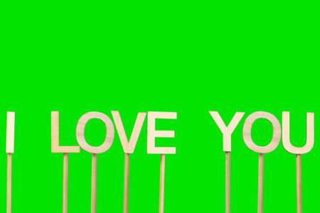 I love you sign made with individual wooden letters on a green chroma background.の写真素材