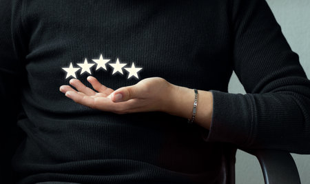Customer evaluation feedback. Giving a five star rating. Seated casual unrecognizable man giving a...