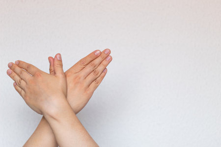 Hands symbolizing a dove isolated on a white textured background. Peace concept.の写真素材