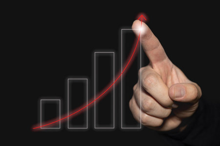 Rising financial charts. Success in business. Person doing a business growth analysis with positive data and economic up arrow. chart analysis.の写真素材