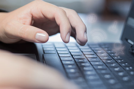 Close-up of the hands of an unrecognizable person typing on the laptop. Texting on the computer...