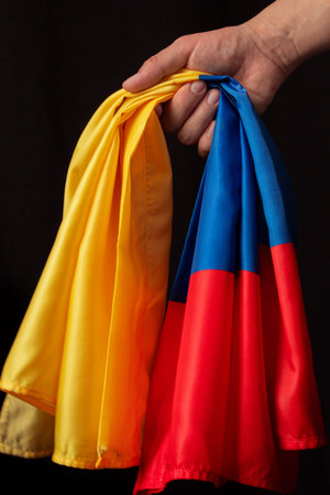 Hand holding Colombian flag. National colors, concept of patriotism, national identity, and...