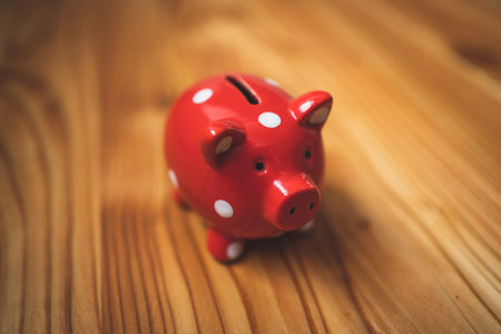 A piggy bank on a nice wooden texture. Vintage style.の写真素材