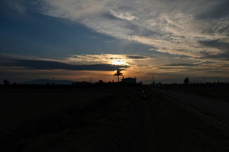 Sunset between the clouds backlitの写真素材