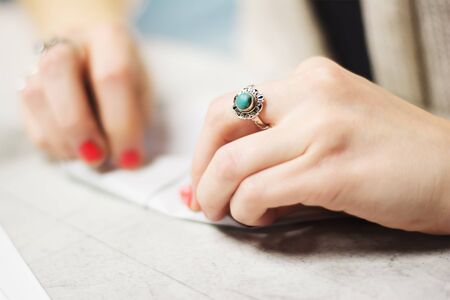 A girl folding cootie catcher to play with her arts and crafts class.の写真素材