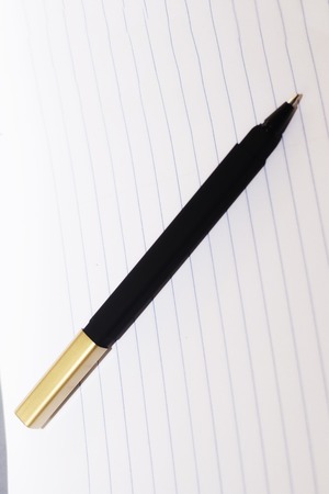 A single black on a lined peace of white paper, ready to go back to school or be an office supply.の写真素材