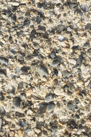 A rough stone and concrete wall texture.の写真素材