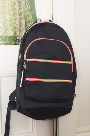 A close up of a backpack hanging on a door. Ready to go back to school. の写真素材