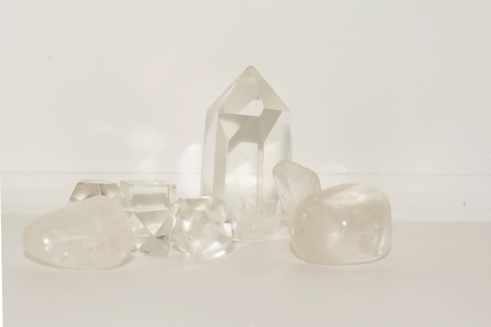 a group of clear quartz and smokey quartz together on a white background.の写真素材