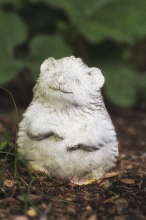 A granite lawn ornament out in a garden.の写真素材