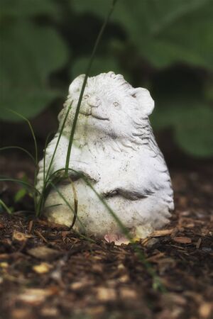 A granite lawn ornament out in a garden.の写真素材