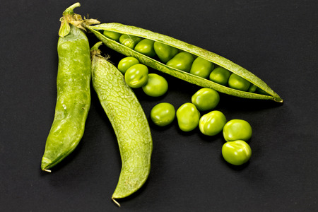 Fresh peas on black background