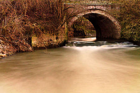 Bridge and water at sunsetの写真素材