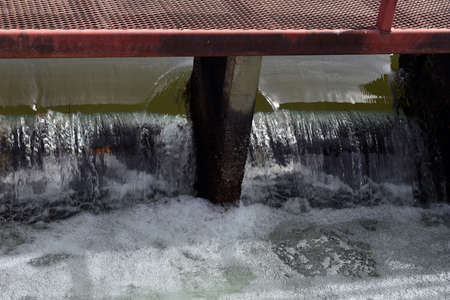 Water flowing fast through lock with micro bubbles