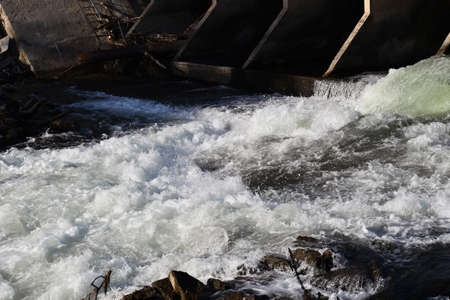 Water rushing from dam holding back snowmelt