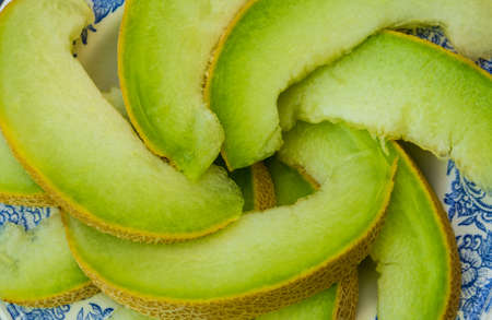 juicy ripe honeydew melon on a plateの写真素材