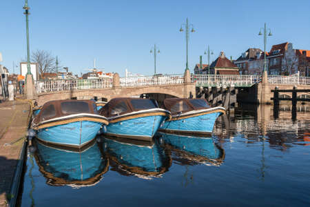 Leiden, the Netherlands - 4 December 2016: motor boats docked in a canal of Leiden in the Netherlandsのeditorial素材