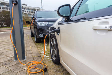 Kijkduin, The Hague, the Netherlands - 13 January 2017: hybrid electric cars charging with electric plug in power stationのeditorial素材