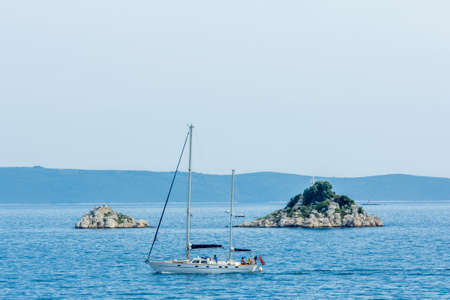 Trogir, Croatia - 8 may 2016: boat cruising past Celic island on the croatian coastのeditorial素材