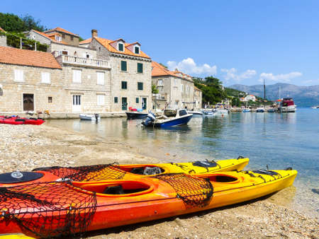 lopud island, Elephiti islands, Croatia -August 6 2018: peacefull coastal scene on the Dalmaitia coast of Croatia with sport kayaks boats and holiday housesのeditorial素材