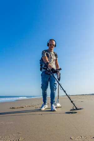 Kijkduin, The Hague, the Netherlands - September 1 2018: man on the beach metal detecting in search of money, gold, treasure and adventureのeditorial素材