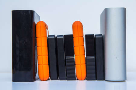 different kinds of external computer storage hard drives - isolated on white backgroundの写真素材