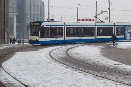 Amsterdam, the Netherlands - January 22 2019: GVB fast tram at Amsterdam central in snow view from aboveのeditorial素材
