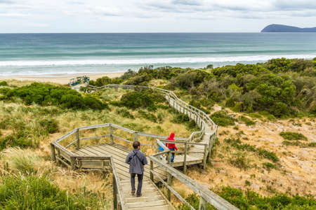 Bruny Island Neck, Tasmania, Australia - December 20, 2016: family walking down walkway on Bruny island neckのeditorial素材