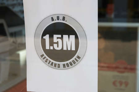 Loosduinen, the hague, the netherlands - April 24 2020: warning sign in  shop window for 1.5 metre social distancingのeditorial素材