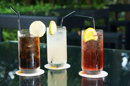 Three ice cold drinks, Cola, Lime and Cranberry Juice                 の写真素材