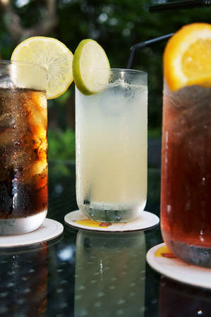 Three ice cold drinks, Cola, Lime and Cranberry Juice               の写真素材