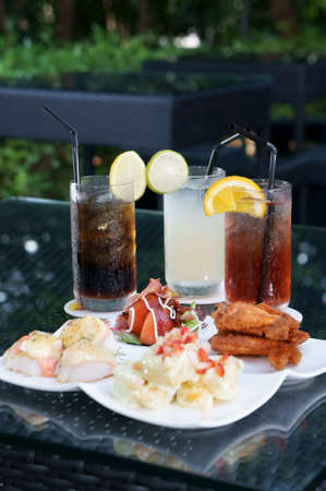 Three colorful drinks with snack ready for serving.            の写真素材