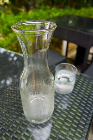 Clear Cold water flash and glass with greenery background. の写真素材
