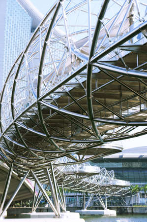 A metallic spiral structure bridge on top of a river.                   のeditorial素材