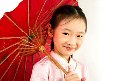 Asian Girl wearing traditional costume holding an umbrellaの写真素材