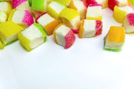 Top pile up with colorful soft chewy sugar coated sweet candies on whiteの写真素材