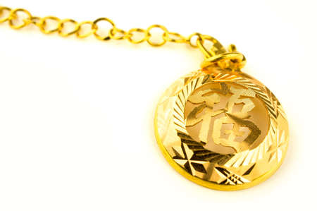 Close up of a Heirloom gold jewelry with chinese character  Blessing  writing on it の写真素材