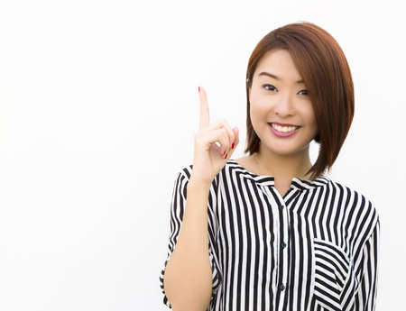 A lady, holding up her finger, with a bright idea  の写真素材