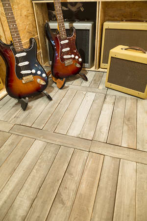 Two electric guitar with amplifiers display around them. の写真素材